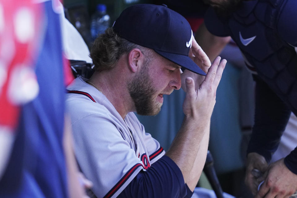 Atlanta Braves relief pitcher A.J. Minter reacts in the dugout after the eighth inning of a baseball game against the Chicago Cubs in Chicago, Friday, June 17, 2022. (AP Photo/Nam Y. Huh)