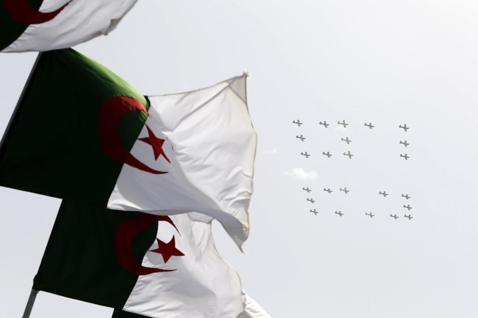 War planes fly to display the number 60 during a military parade to mark the 60th anniversary of Algeria's independence, Tuesday, July 5, 2022 in Algiers. Algeria is celebrating 60 years of independence from France with nationwide ceremonies, a pardon of 14,000 prisoners and its first military parade in years. (AP Photo/Toufik Doudou)