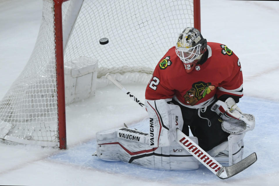 Chicago Blackhawks goalie Alex Stalock (32) misses a goal by Columbus Blue Jackets' Kirill Marchenko during the second period of an NHL hockey game Friday, Dec. 23, 2022, in Chicago. (AP Photo/Paul Beaty)