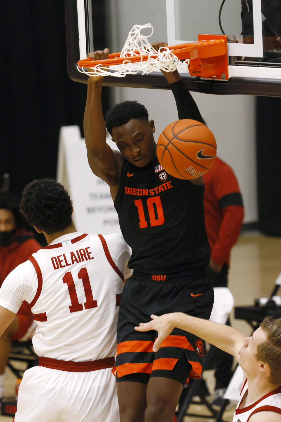 Oregon State forward Warith Alatishe (10) dunks in front of Stanford forward Jaiden Delaire (11) during the first half of an NCAA college basketball game in Stanford, Calif., Saturday, Feb. 27, 2021. (AP Photo/Josie Lepe)