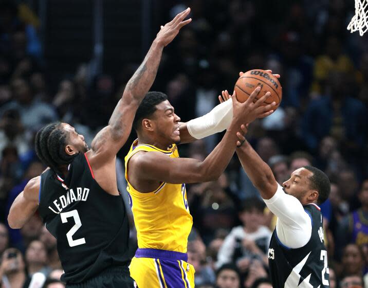 Los Angeles, California February 28, 2024-Lakers Rui Hachimura drives between Clippers Kawhi Leonard (2) and Norman Powell in the fourth quarter at Crypto.com Arena Wednesday. (Wally Skalij/Los Angeles Times)