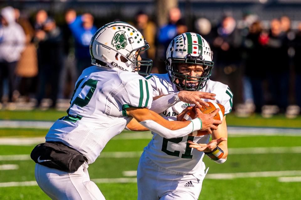 Dartmouth's Jackson Hart hands the ball off to Ray Gramlich.