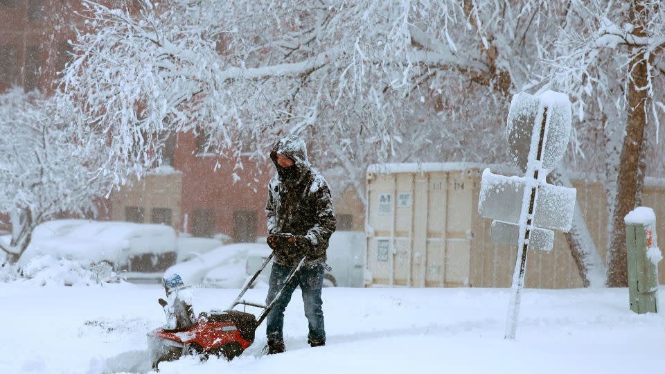 A person uses a snowblower to clear a sidewalk as a snowstorm dumps several inches of snow on the area in Des Moines, Iowa, on Tuesday. - Joe Raedle/Getty Images
