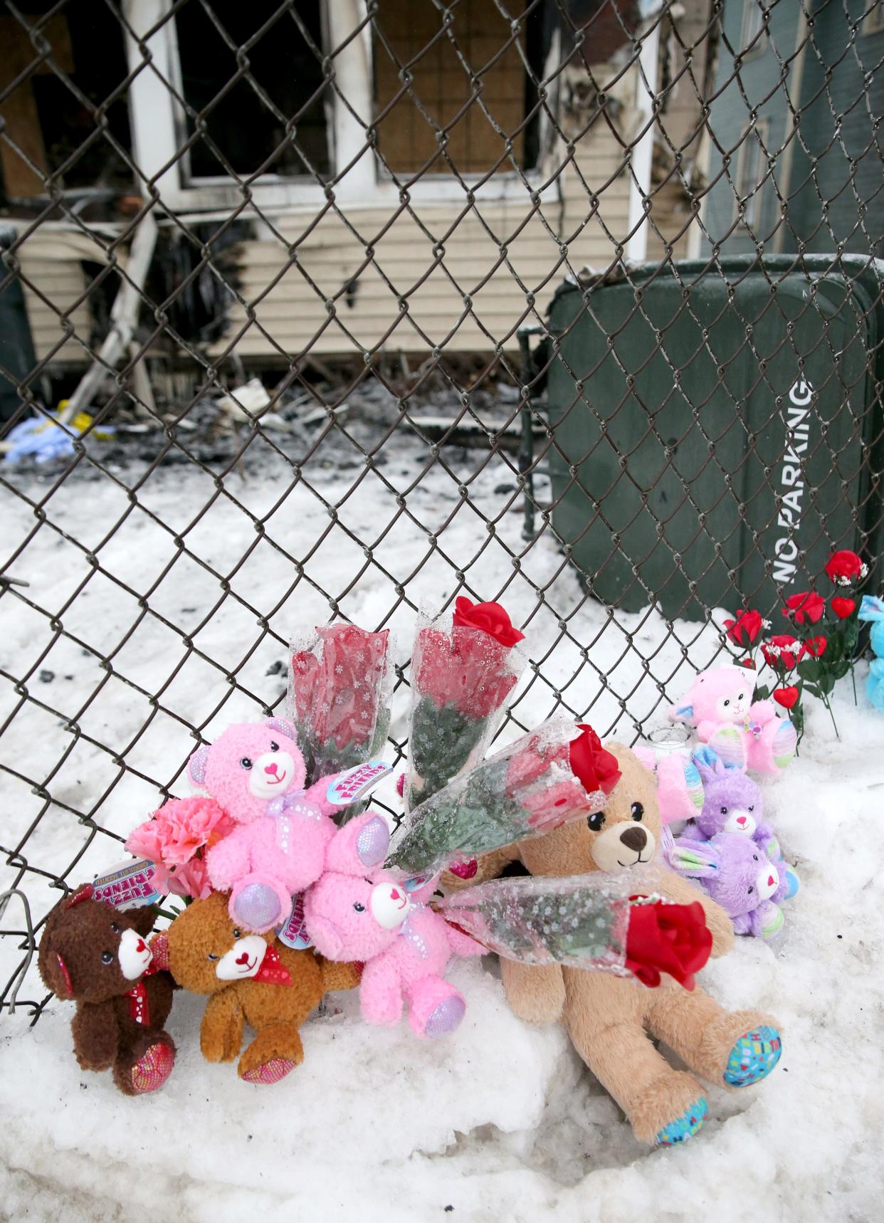 People have created a memorial of stuffed animals, candles and flowers, seen Tuesday, Jan. 23, 2024, at the scene of Sunday’s house fire at 222 N. LaPorte Ave. that killed five children.