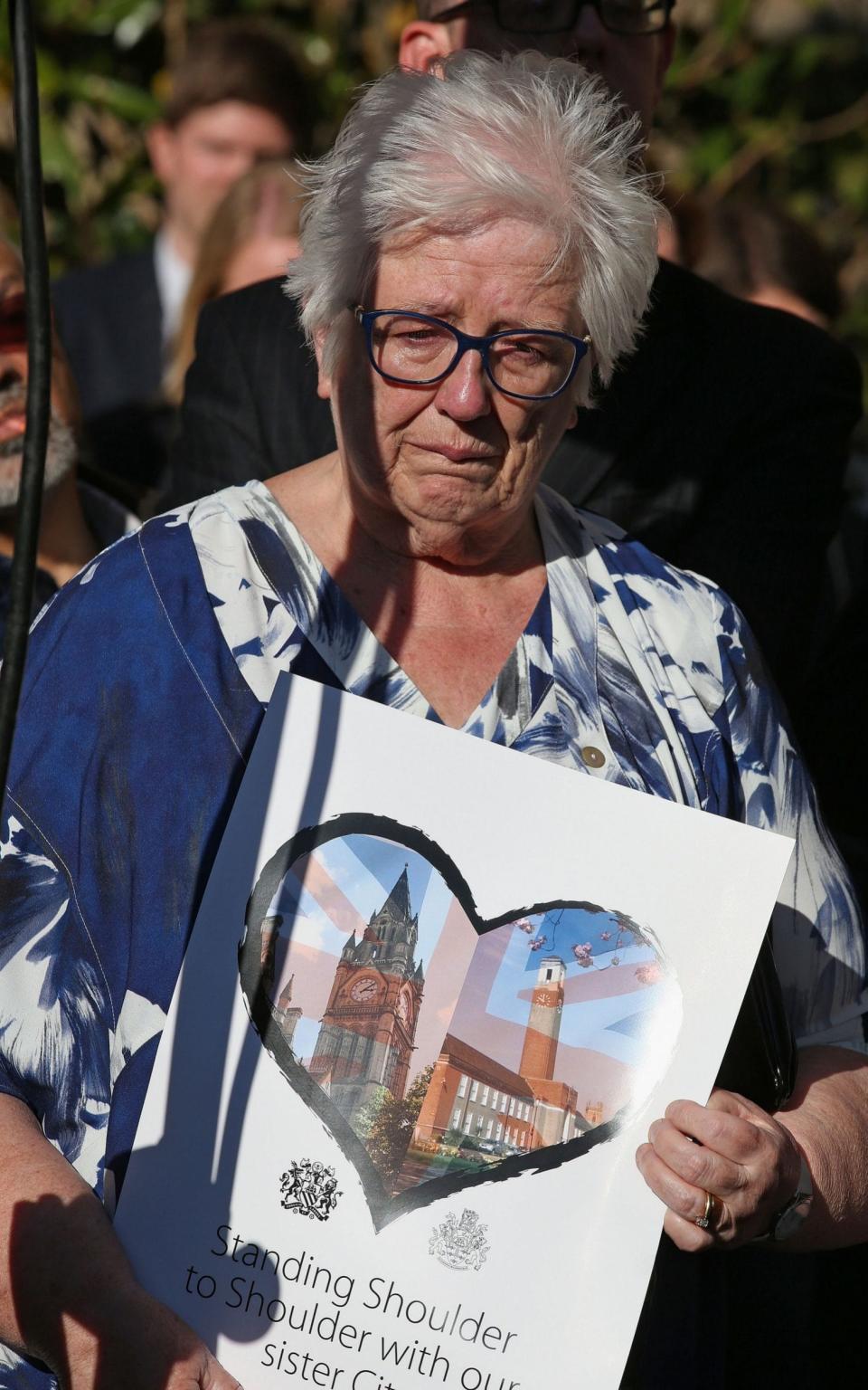 People attend a vigil in Albert Square, Manchester - Credit: Martin Rickett/PA Wire