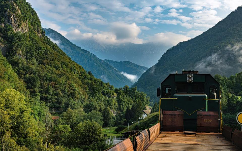 The locomotive pulls carriages to see the valleys and mountains of the Julian Alps, Slovenia - iStock/Getty