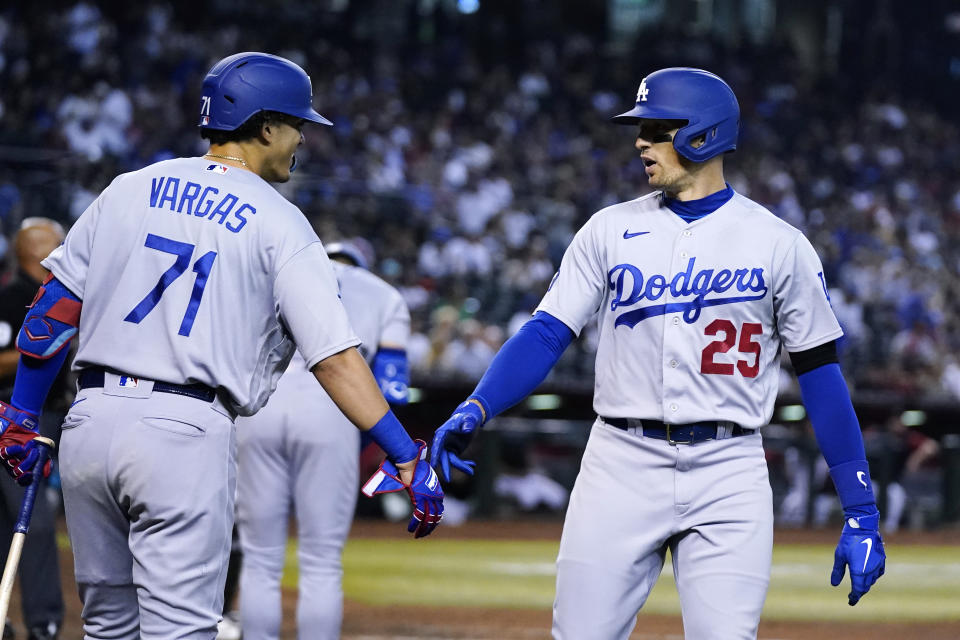 Los Angeles Dodgers' Trayce Thompson (25) celebrates his home run against the Arizona Diamondbacks with Miguel Vargas (71) during the fourth inning of a baseball game in Phoenix, Wednesday, Sept. 14, 2022. (AP Photo/Ross D. Franklin)