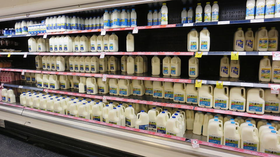 Coles shelves are low on branded milk stock as consumers purchase more expensive brands in support of local farmers on May 24, 2016. Image: Getty