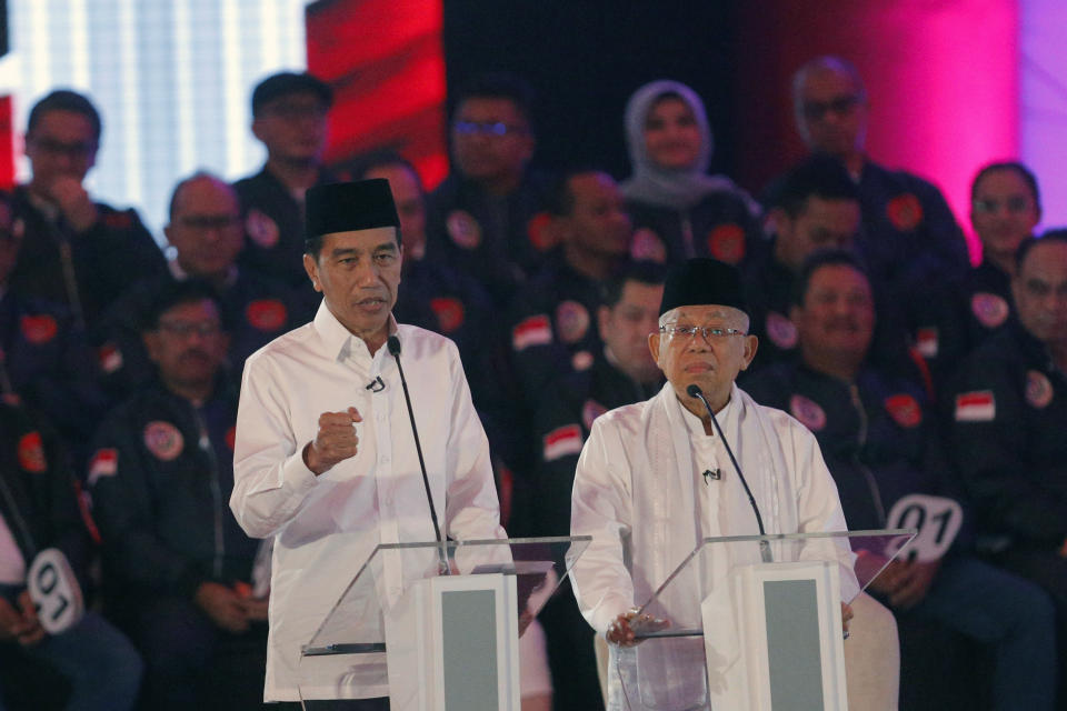 Indonesian President Joko Widodo delivers a speech, with running mate Ma'ruf Amin, right, during a televised debate in Jakarta, Indonesia, Thursday, Jan. 17, 2019. Indonesia is gearing up to hold its presidential election on April 17 that will pit in the incumbent against the former general.(AP Photo / Tatan Syuflana)