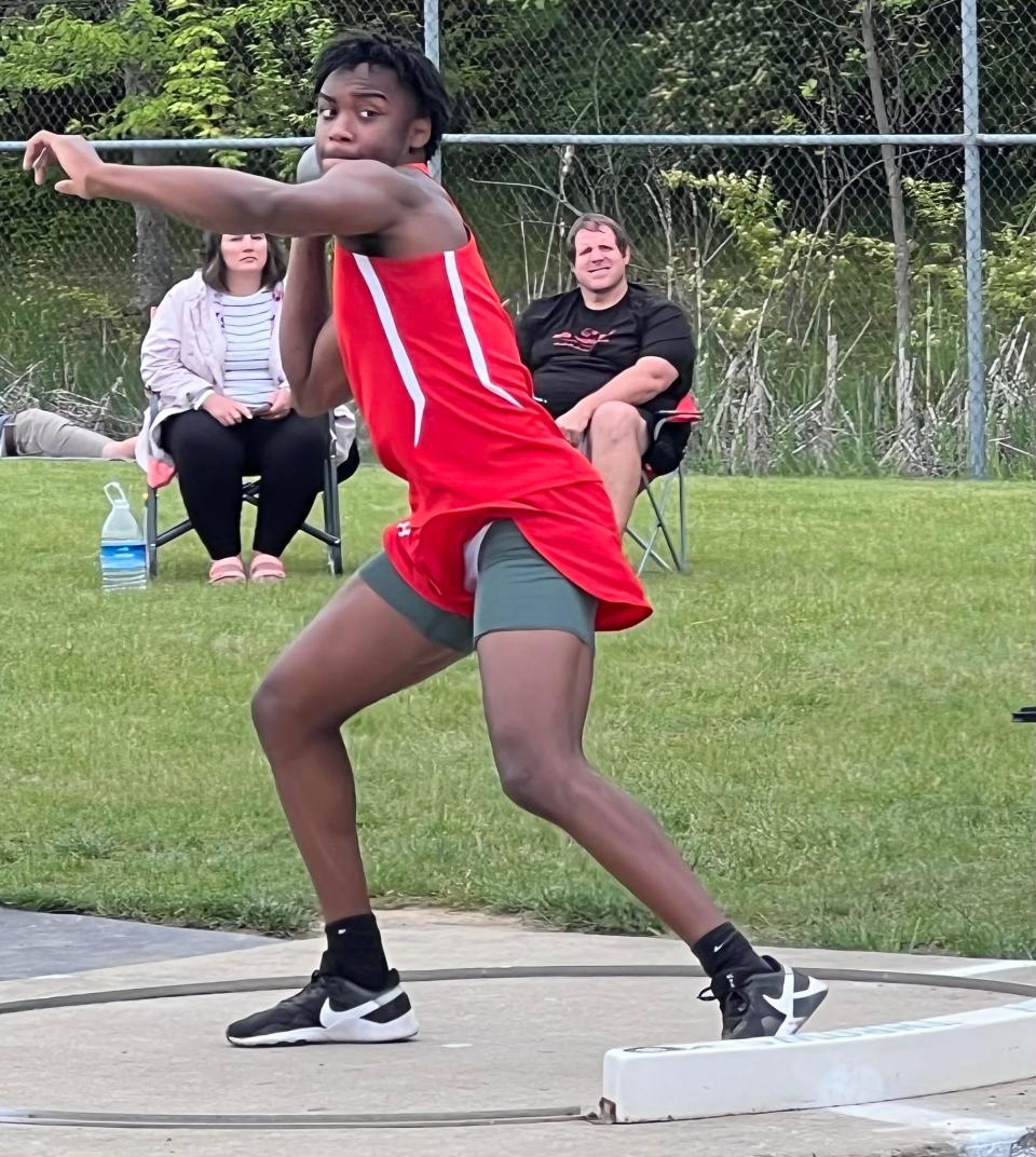 Centennial's Dewayne Davis competes in the shot put in the Division I, district 2 meet Tuesday at Hilliard Darby. Davis finished 13th but earned a regional berth by winning the discus.