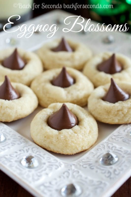 <p>Back For Seconds</p><p>These Eggnog Blossoms are a festive twist on the traditional peanut butter blossoms. Soft, chewy eggnog cookies are rolled in sugar and topped with a kiss! </p><p><strong>Get the recipe: <a href="https://cravinghomecooked.com/peanut-butter-blossoms/" rel="nofollow noopener" target="_blank" data-ylk="slk:Eggnog Blossoms;elm:context_link;itc:0;sec:content-canvas" class="link rapid-noclick-resp">Eggnog Blossoms</a></strong></p>
