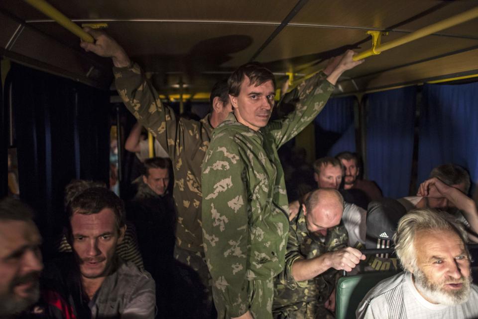 Members of the pro-Russian rebels, who are prisoners-of-war, in a bus after being exchanged, north of Donetsk, eastern Ukraine