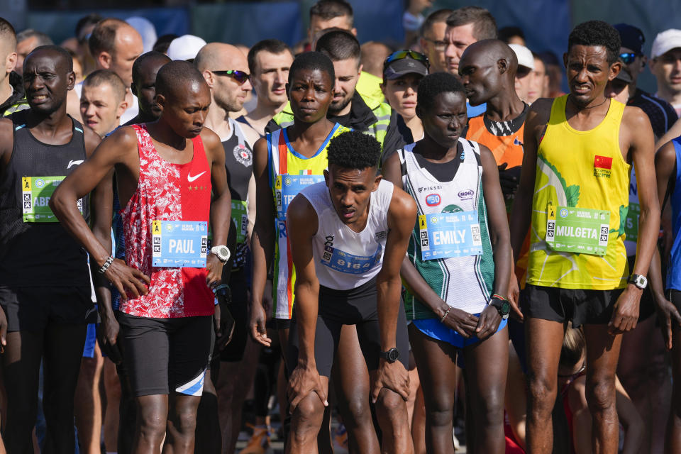 Tachlowini Gabriyesos, Eritrean born long distance runner, center, prepares for the half marathon race in Belgrade, Serbia, Sunday, April 23, 2023. Gabriyesos fled his native Eritrea and walked through the desert to reach Israel when he was just 12 years old. He is now running marathons, sending a message of hope and endurance to all refugees like himself. (AP Photo/Darko Vojinovic)