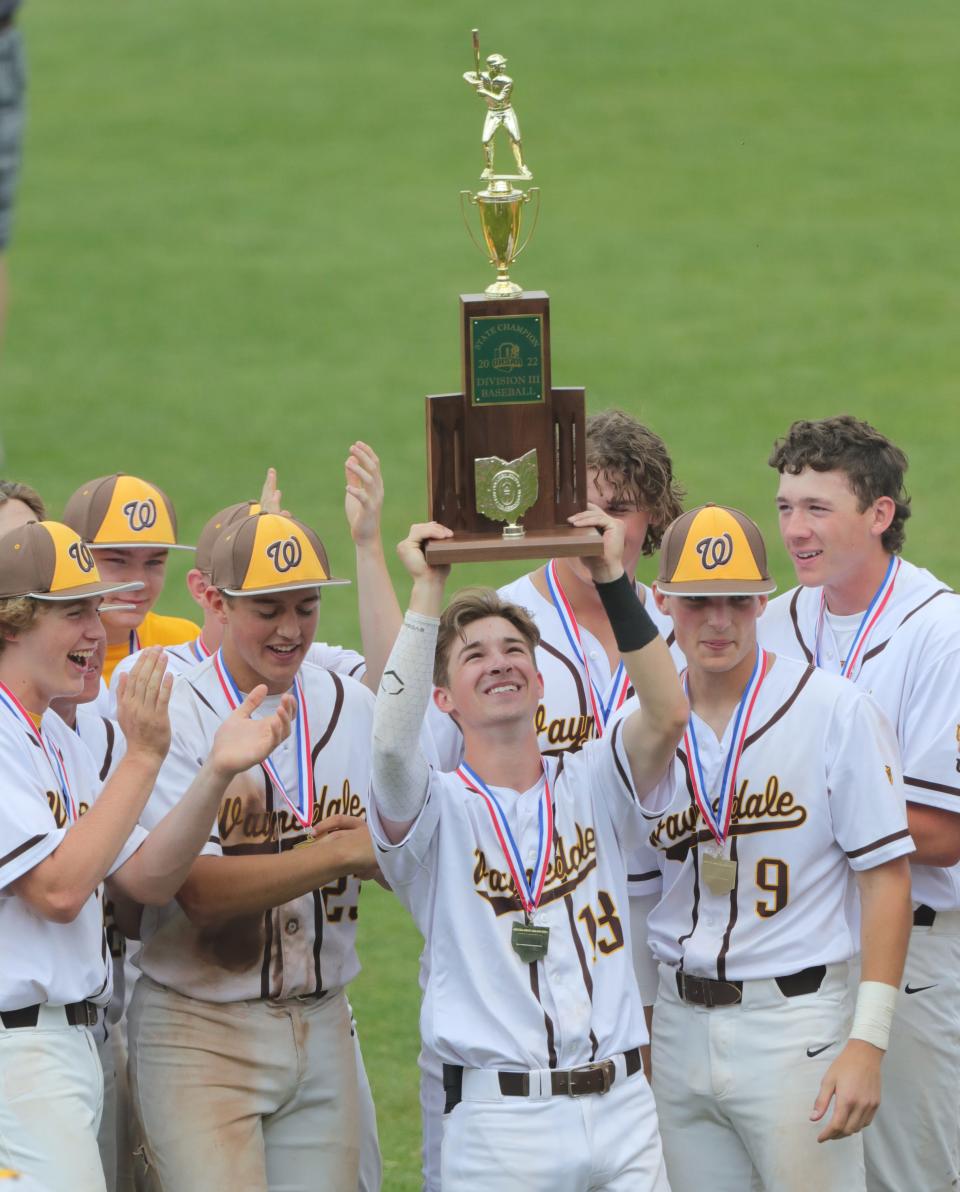 Waynedale's Connor Gatti hoists the Division III State Championship trophy after his game winning 8th inning hit against Milan Edison for a 2-1 win on Saturday, June 11, 2022 in Akron, Ohio, at Canal Park.