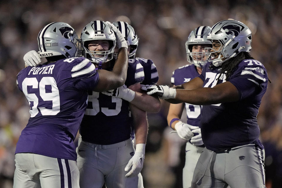 Kansas State tight end Will Swanson, second from left, celebrates with teammates after scoring a touchdown during the second half of an NCAA college football game against TCU Saturday, Oct. 21, 2023, in Manhattan, Kan. (AP Photo/Charlie Riedel)