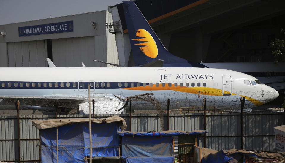 A Jet Airways aircraft is seen parked at a hanger at Chhatrapati Shivaji Maharaj International Airport in Mumbai, Monday, March 25, 2019. The chairman of India’s private Jet Airways has quit amid mounting financial woes forcing the airline to suspend operations on 14 international routes with more than 80 planes grounded. (AP Photo/Rafiq Maqbool)