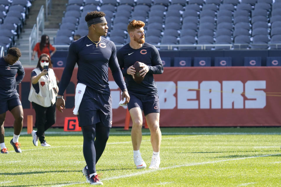 Chicago Bears quarterback Andy Dalton, left, and Justin Fields warm up before an NFL football game against the Cincinnati Bengals Sunday, Sept. 19, 2021, in Chicago. (AP Photo/Nam Y. Huh)