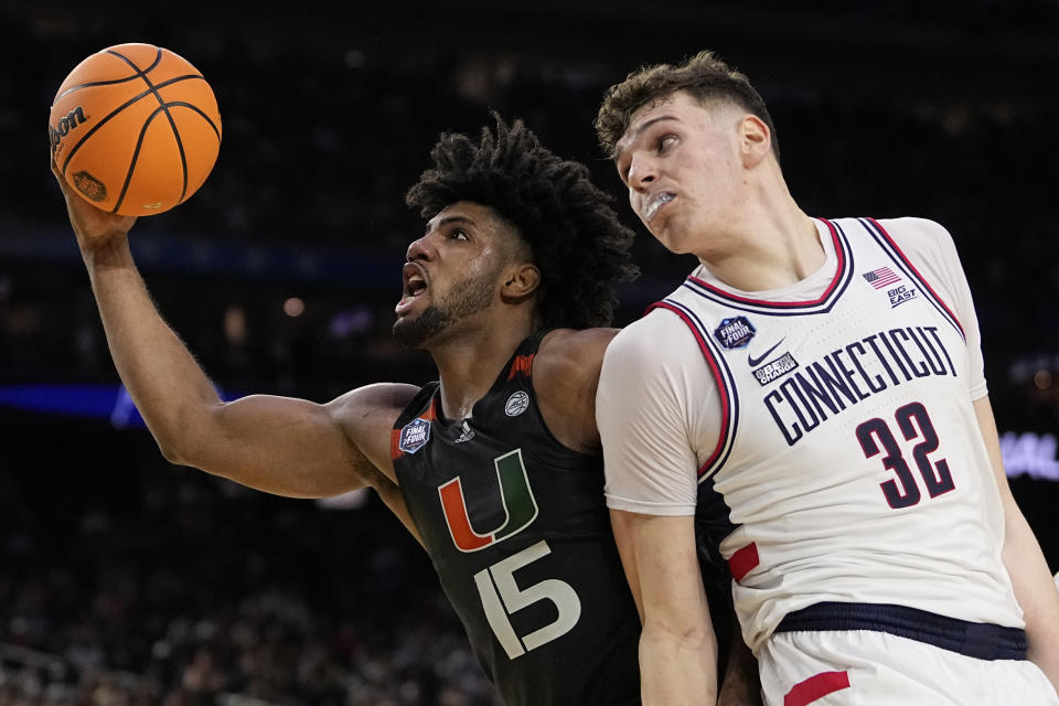 Miami forward Norchad Omier drives to the basket past Connecticut center Donovan Clingan during the second half of a Final Four college basketball game in the NCAA Tournament on Saturday, April 1, 2023, in Houston. (AP Photo/David J. Phillip)