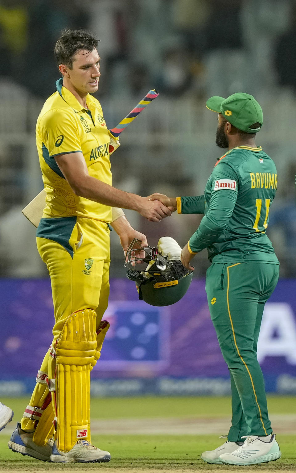 Australia's captain Pat Cummins, left, shake hands with South Africa's captain Temba Bavuma after winning the ICC Men's Cricket World Cup second semifinal match against South Africa in Kolkata, India, Thursday, Nov. 16, 2023. (AP Photo/Mahesh Kumar A.)