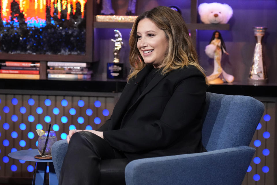 Ashley Tisdale, smiling on a talk show set