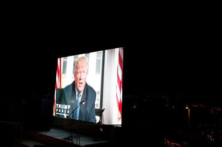 U.S. presidential nominee Donald Trump speaking to supporters in a pre-recorded message shown on big screen during a convention organised by the Israeli branch of the U.S. Republican party campaigning for him in Jerusalem October 26, 2016. REUTERS/Ammar Awad/File Photo