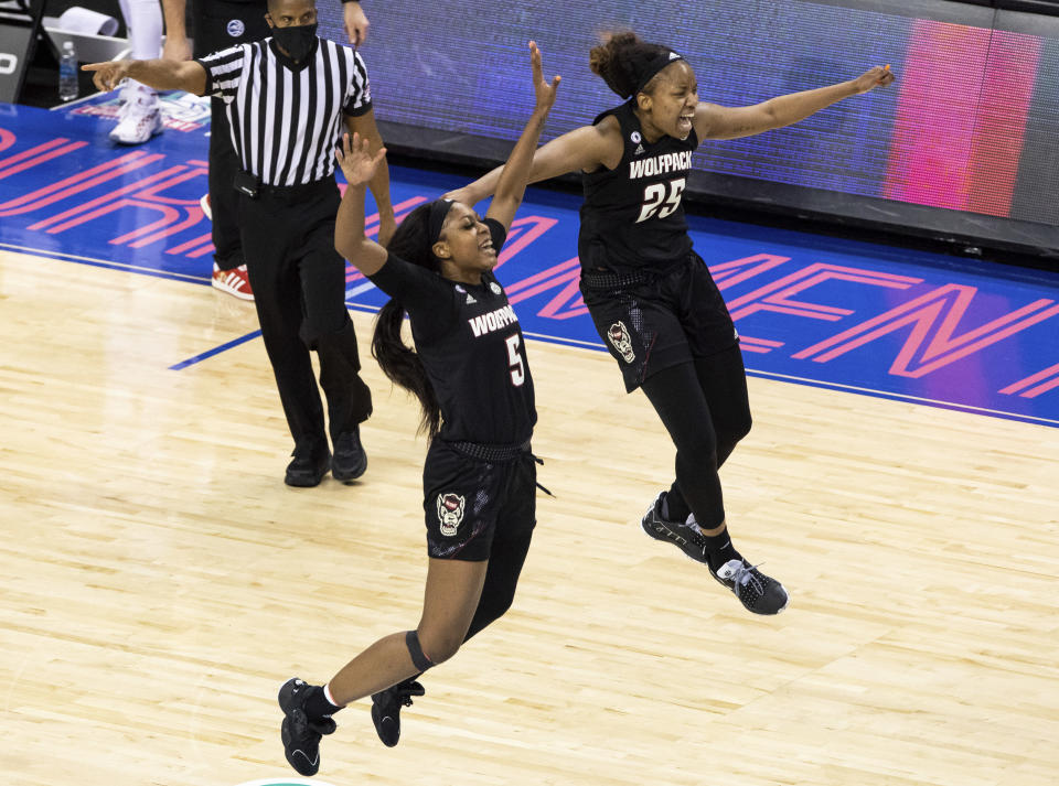 North Carolina State's Jada Boyd (5) and Kayla Jones (25) celebrate after beating Louisville in the Atlantic Coast Conference NCAA women's college basketball championship game in Greensboro, N.C., Sunday, March 7, 2021. (AP Photo/Ben McKeown)