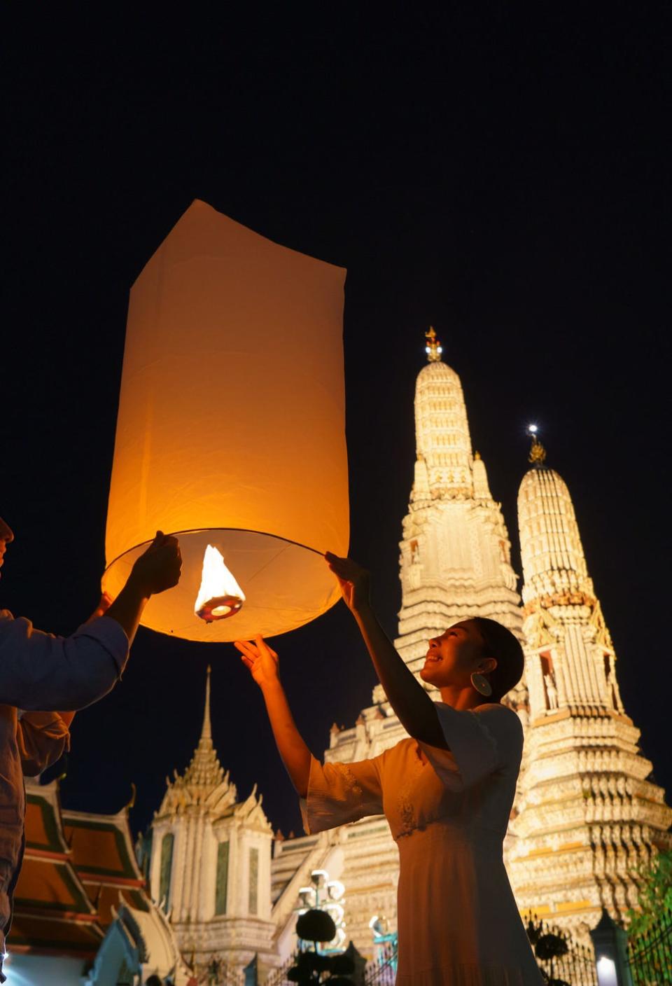 Lighting a floating lantern in Thailand