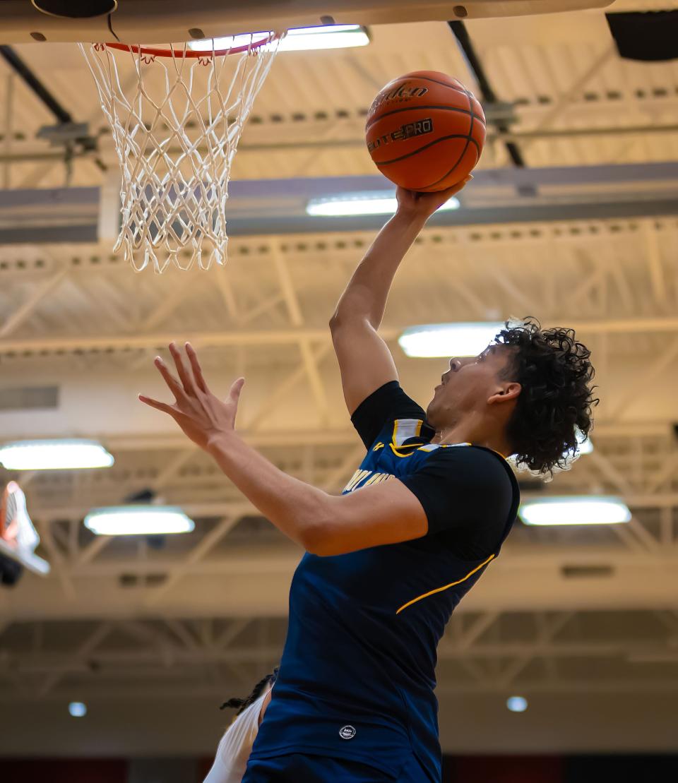 Stony Point Tigers guard Junior Goodlet shoots against the Manor Mustangs during a District 25-6A basketball game on Jan 19 at Manor High School.