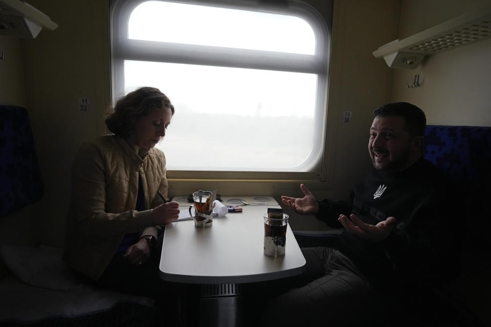 Ukrainian President Volodymyr Zelenskyy gestures during an interview with Julie Pace, senior vice president and executive editor of The Associated Press, on a train traveling from the Sumy region to Kyiv, Ukraine, Tuesday March 28, 2023. In the interview, Zelenskyy warned that unless his nation wins a drawn-out battle in the key eastern city of Bakhmut, then Russia could begin building international support for a deal that could require Ukraine to make unacceptable compromises. (AP Photo/Efrem Lukatsky)