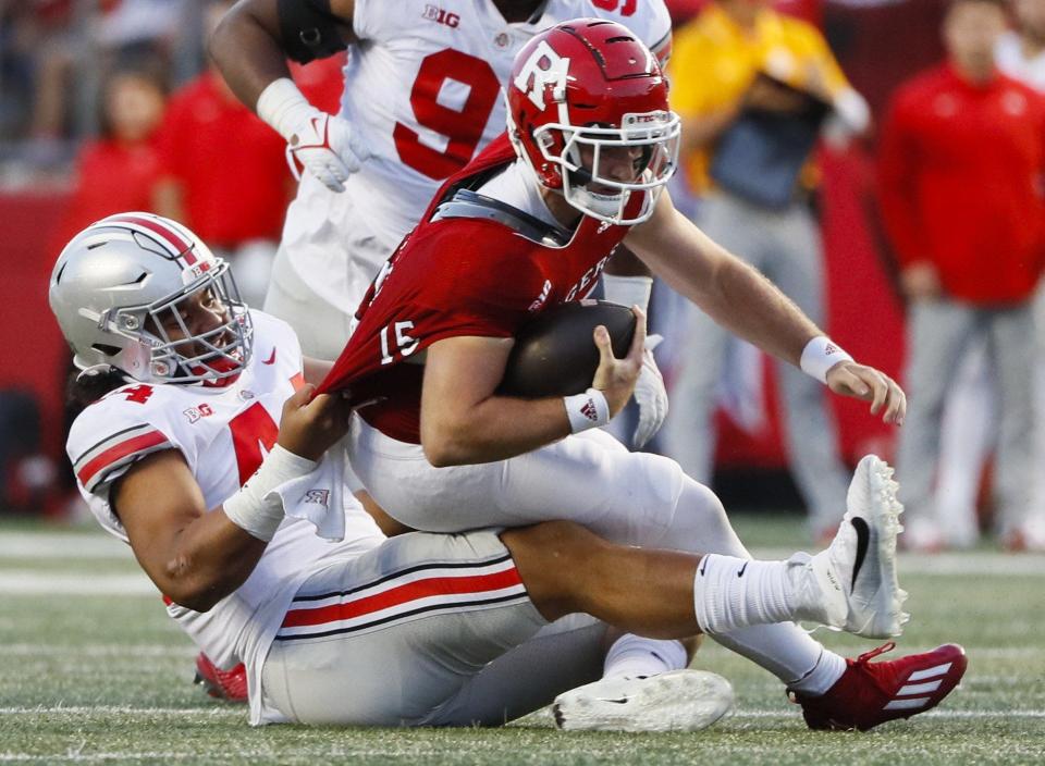 Ohio State Buckeyes defensive lineman J.T. Tuimoloau (44) brings down Rutgers Scarlet Knights quarterback Cole Snyder (15) during the fourth quarter of a NCAA Division I football game between the Rutgers Scarlet Knights and the Ohio State Buckeyes on Saturday, Oct. 2, 2021 at SHI Stadium in Piscataway, New Jersey.