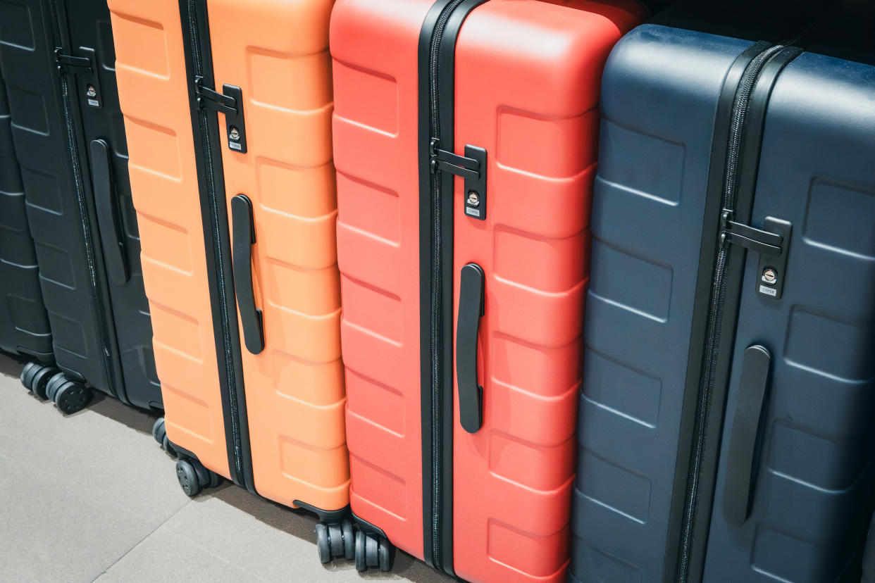 cyber monday luggage deals row of hardshell suitcases lined up