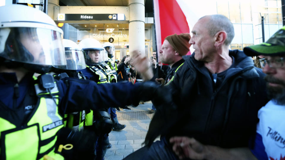 Protesters confront police and get shoved back during a demonstration, part of a convoy-style protest participants are calling "Rolling Thunder", Friday, April 29, 2022, in Ottawa, Ontario. (Sean Kilpatrick/The Canadian Press via AP)