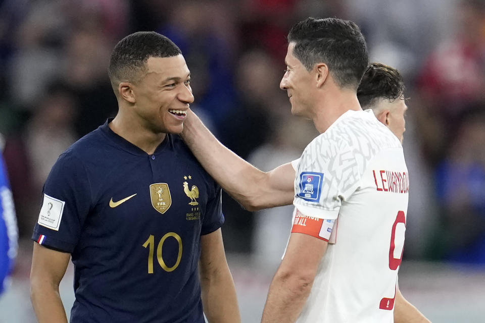 France's Kylian Mbappe, left, and Poland's Robert Lewandowski, right, speak after the World Cup round of 16 soccer match between France and Poland, at the Al Thumama Stadium in Doha, Qatar, Sunday, Dec. 4, 2022. (AP Photo/Natacha Pisarenko)