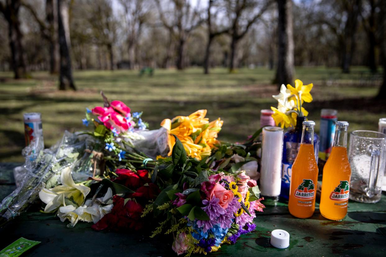Candles, flowers, notes and other items sit on a picnic table honoring the victims of a March 7 shooting at Bush’s Pasture Park. Jose Vasquez-Valenzuela, 16, died at the scene. Two other teens were also shot and hospitalized