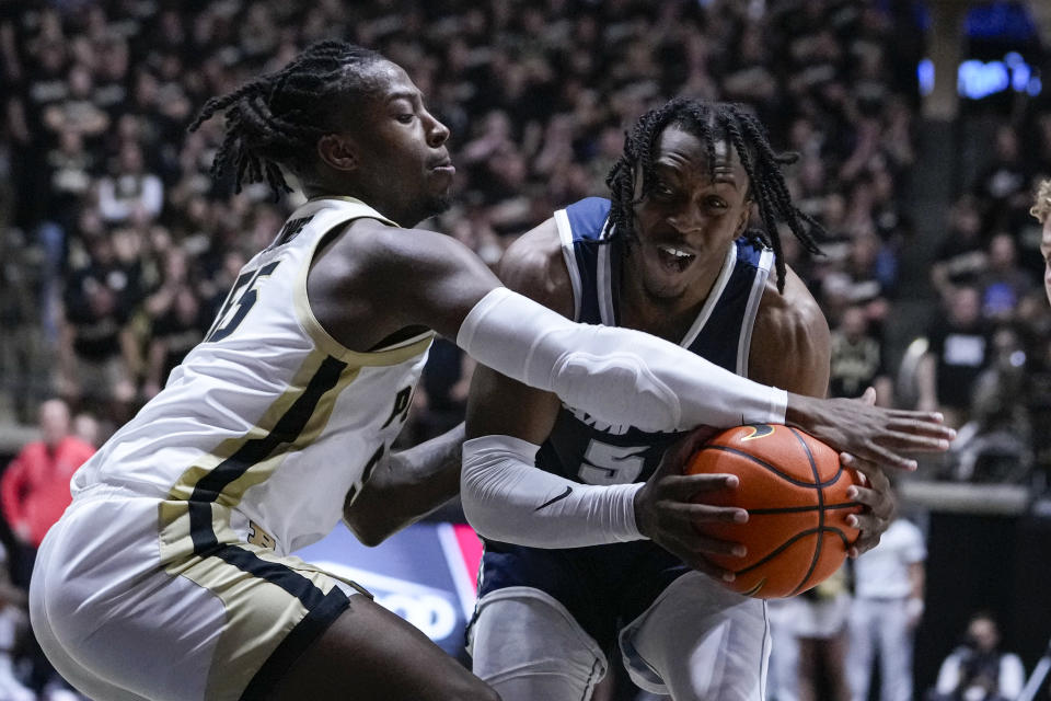 Purdue guard Lance Jones (55) knocks the ball away from Samford guard A.J. Staton-McCray (5) during the first half of an NCAA college basketball game in West Lafayette, Ind., Monday, Nov. 6, 2023. (AP Photo/Michael Conroy)