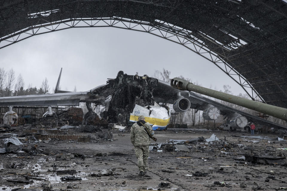 A Ukrainian serviceman walks near the wreckage of a cargo aircraft amid the destruction at the military airport in the town of Hostomel, on the outskirts of Kyiv, Ukraine, after the Ukrainian army secured the area following the withdrawal of the Russian army from the Kyiv region, April 3, 2022. / Credit: Narciso Contreras/Anadolu Agency/Getty