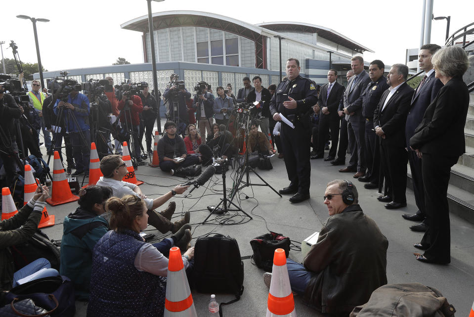 <p>San Bruno Police Chief Ed Barberini, center right, speaks at a news conference in San Bruno, Calif., Wednesday, April 4, 2018. A woman suspected of shooting three people at YouTube headquarters before killing herself was furious with the company because it had stopped paying her for videos she posted on the platform, her father said Tuesday, April 3, 2018. (Photo: Jeff Chiu/AP) </p>