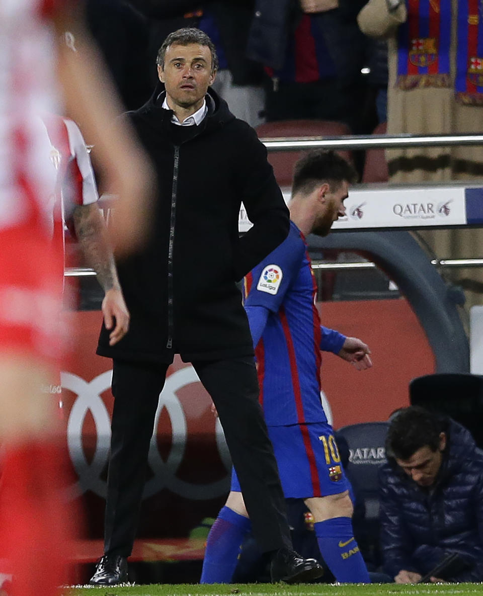 FC Barcelona's coach Luis Enrique, left, stands next Lionel Messi after been substituted during the Spanish La Liga soccer match between FC Barcelona and Sporting Gijon at the Camp Nou stadium in Barcelona, Spain, Wednesday, March 1, 2017. Luis Enrique says he will not stay as Barcelona coach after this season. The surprise announcement was made following the team’s 6-1 win over Sporting Gijon in the Spanish league on Wednesday. (AP Photo/Manu Fernandez)
