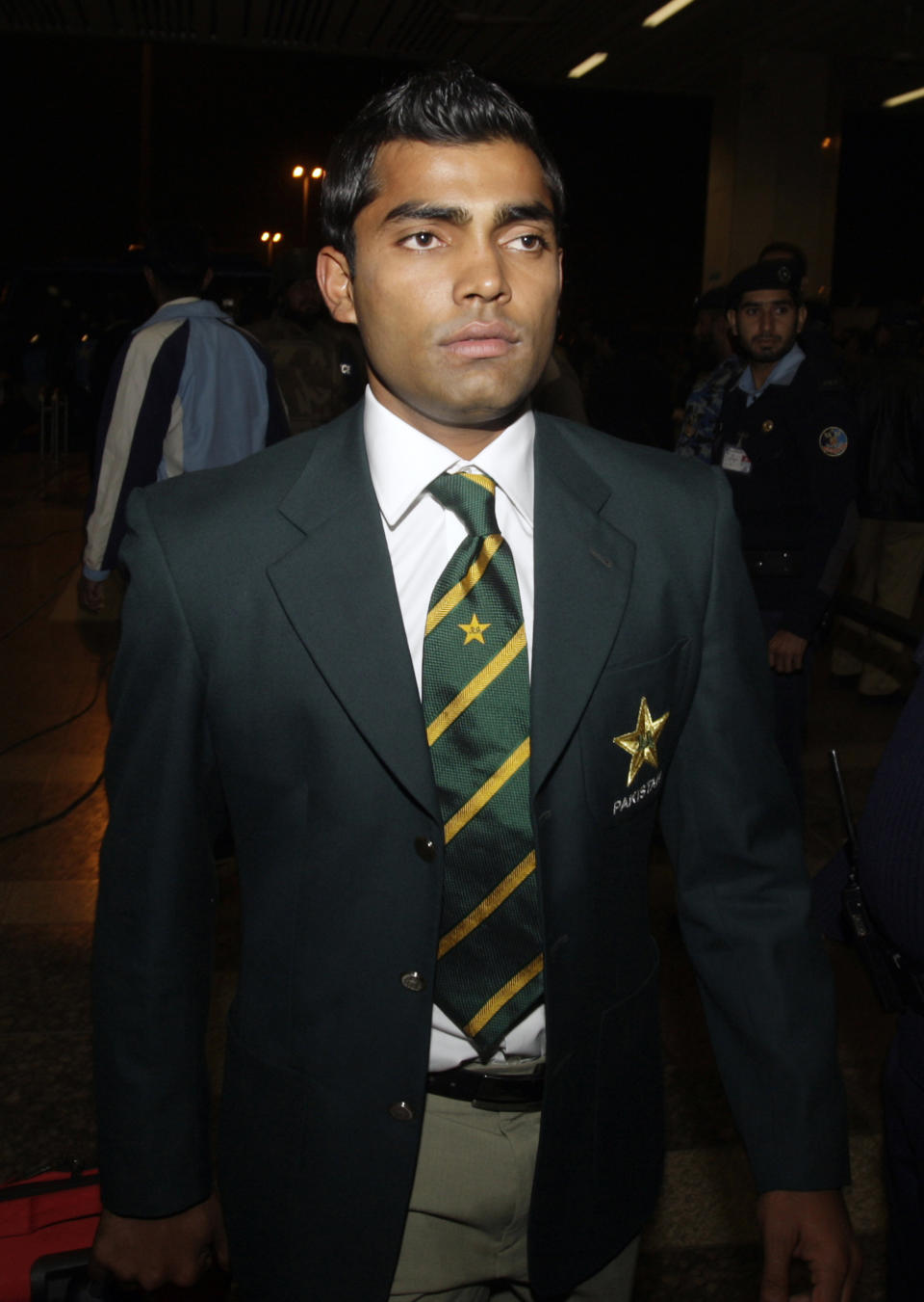 FILE - In this Thursday, Feb. 10, 2011 file photo, Pakistani cricketer Umar Akmal arrives at Allama Iqbal airport to leave for Bangladesh to participate in the upcoming World Cup, at Lahore, Pakistan. On Saturday, Feb. 1, 2014, police detained Pakistan cricketer Umar Akmal and charged him with slapping a traffic sergeant after violating a traffic signal in Lahore. (AP Photo/K.M.Chaudary, File)