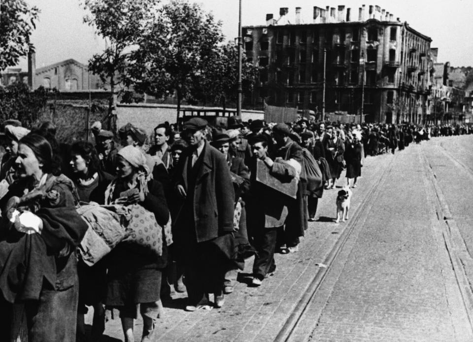 A black-and-white photograph of long lines of people