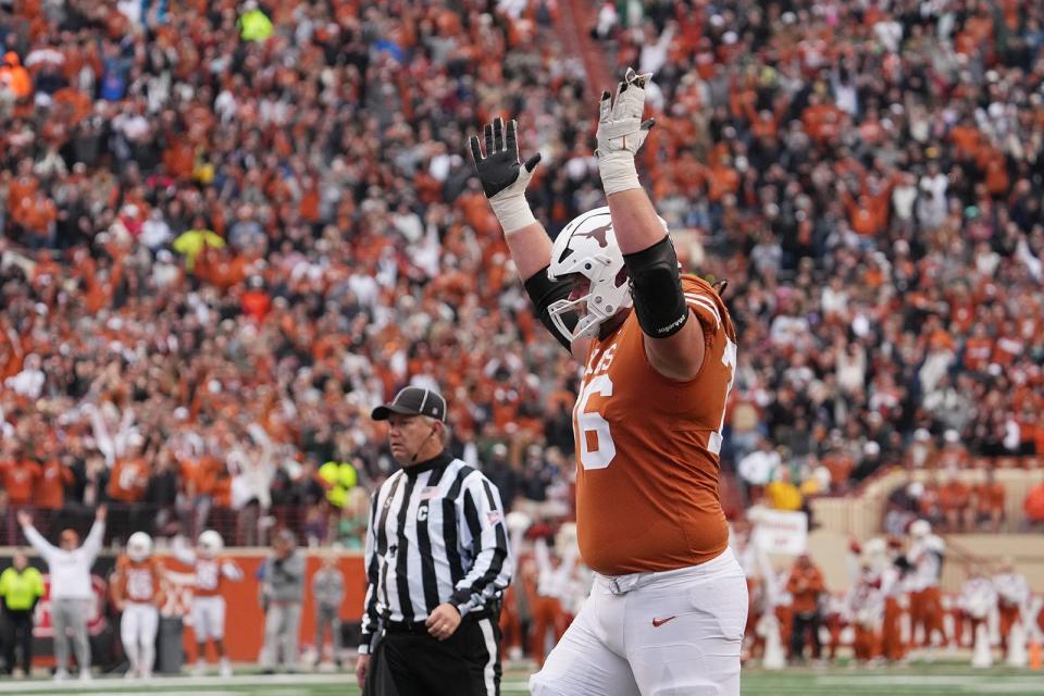 Texas left guard Hayden Conner, signaling a touchdown against Baylor, started every game last season. He is one of five offensive line starters who will return this fall, joining left tackle Kelvin Banks Jr., center Jake Majors, right guard Cole Hutson and right tackle Christian Jones.