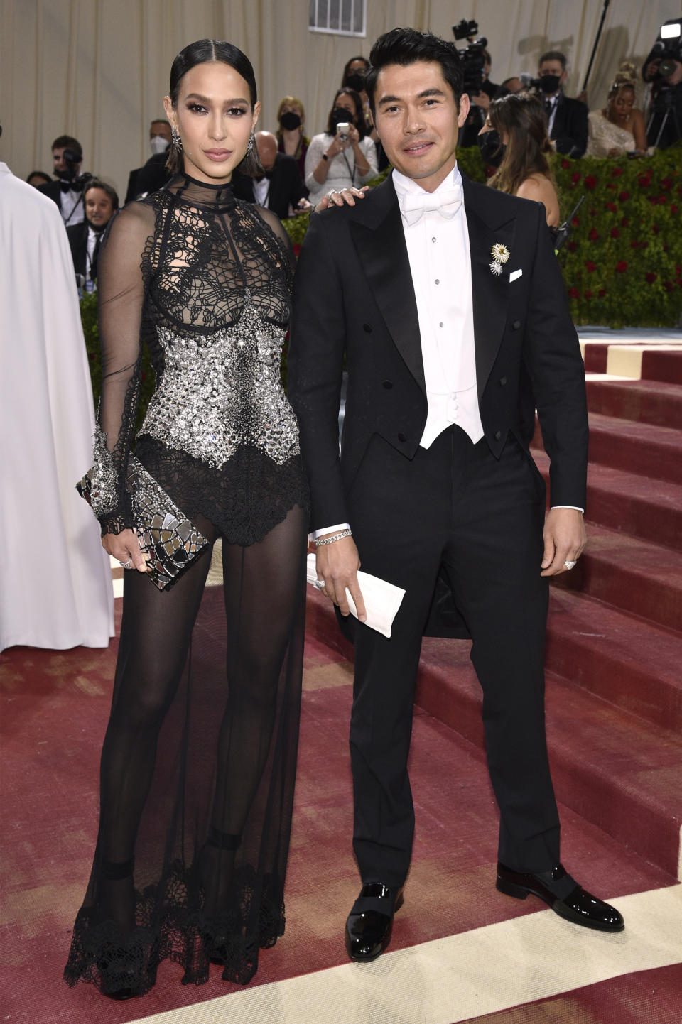 FILE - Henry Golding, right, and Liv Lo attend The Metropolitan Museum of Art's Costume Institute benefit gala on Monday, May 2, 2022, in New York. Parties are back, and they've brought with them the potential for some dress code chaos. White tie, black tie, black tie creative/festive, semi-formal. Pre-pandemic guidelines for attire in an exhausted world more used to sweats and sneakers may take some extra re-entry energy. (Photo by Evan Agostini/Invision/AP)