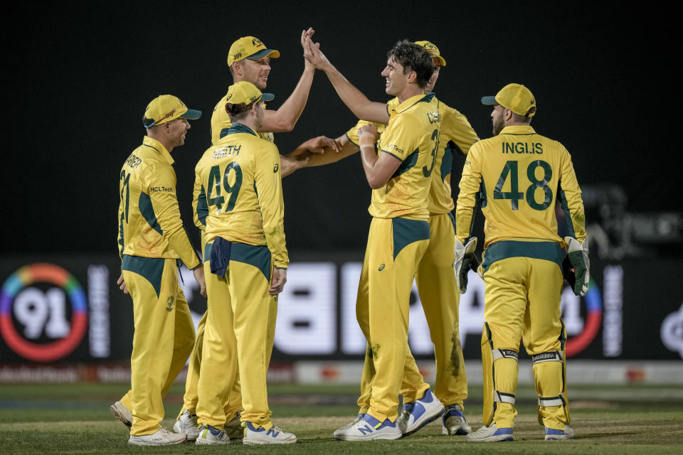 Australian players celebrates the dismissal of New Zealand's Matt Henry during the ICC Men's Cricket World Cup match between Australia and New Zealand in Dharamshala, India,Saturday, Oct. 28, 2023. (AP Photo/Ashwini Bhatia)