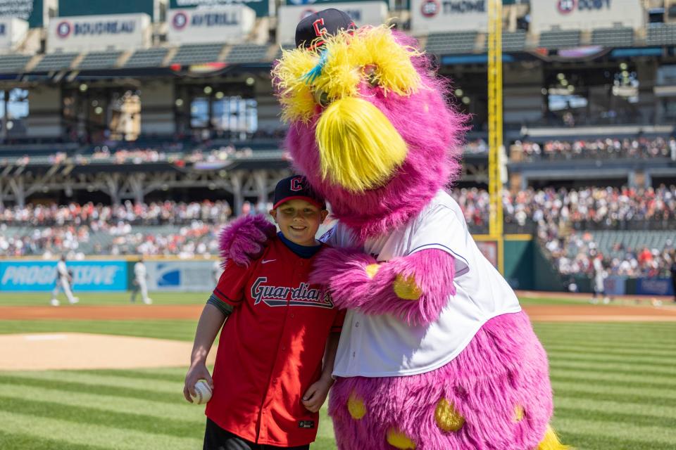 Micah Galuzny, 11, poses with Slider after throwing out the first pitch at a Cleveland Guardians game on Wednesday, April 12, 2023.