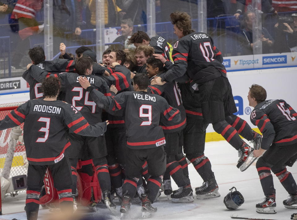 Canada players celebrate after defeating Russia in the gold medal game at the World Junior Hockey Championships, Sunday, Jan. 5, 2020, in Ostrava, Czech Republic. (Ryan Remiorz/The Canadian Press via AP)
