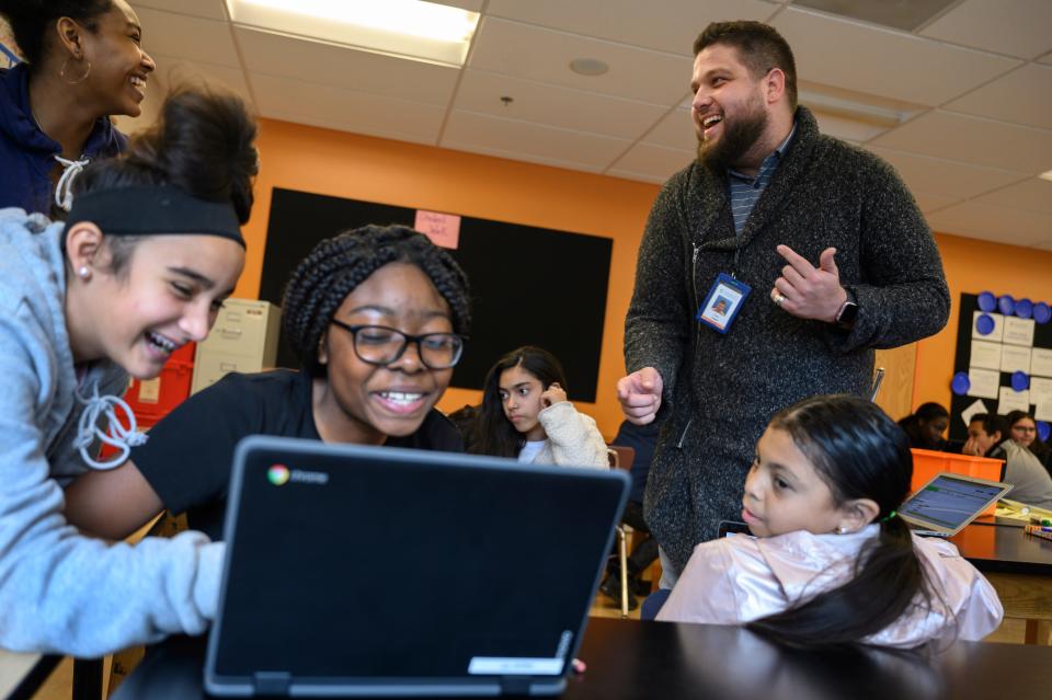 Justin Lopez-Cardoze, right, teaches a 7th grade science class at Capital City Public Charter School in Washington, DC on November 7, 2019. Lopez-Cardoze was named the city's teacher of the year last month and is using the $8,000 in prize money to set up a scholarship for a high school senior.