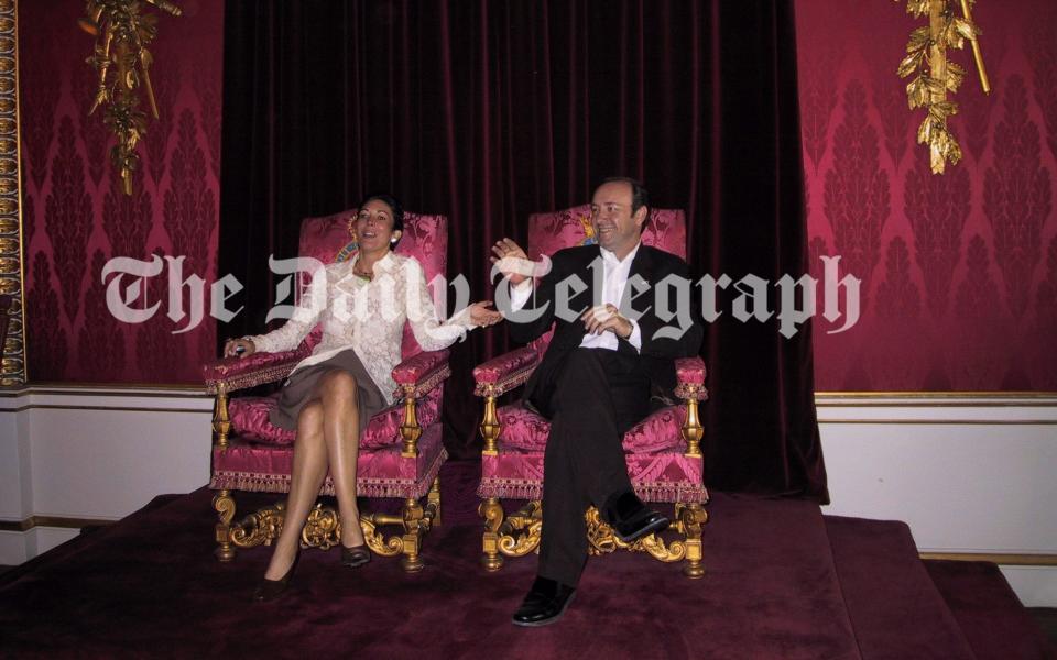 Ghislaine Maxwell and Kevin Spacey sitting on thrones belonging to the Queen and the Duke of Edinburgh at Buckingham Palace in 2002 - THE TELEGRAPH