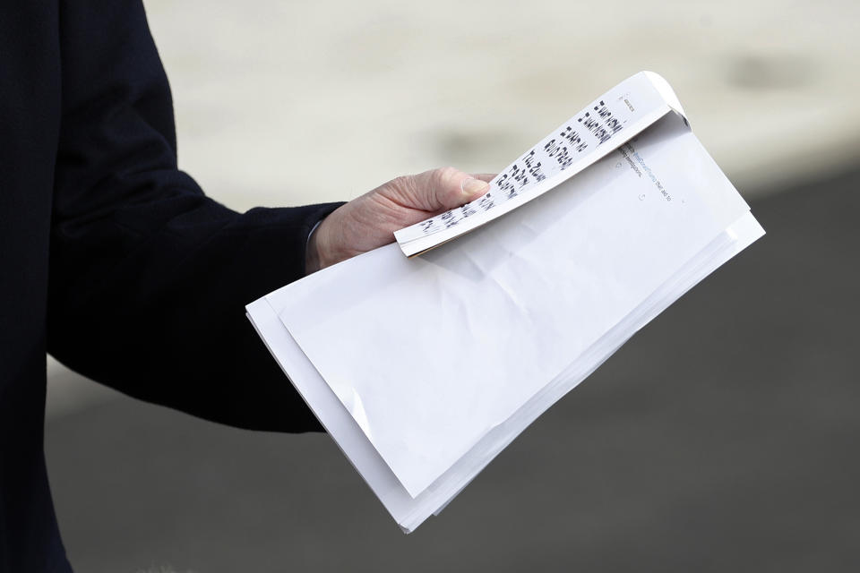 President Donald Trump holds notes and papers as he talks to the media on his way to the Marine One helicopter, Wednesday, Nov. 20, 2019, as he leaves the White House in Washington, en route to Texas. (AP Photo/Patrick Semansky)