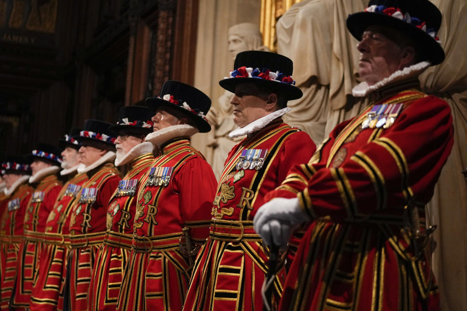Yeomen Warders perform the ceremonial search of the Palace of Westminster prior to the State Opening of Parliament in London, Tuesday, May 10, 2022. Buckingham Palace said Queen Elizabeth II will not attend the opening of Parliament on Tuesday amid ongoing mobility issues. (AP Photo/Alastair Grant, Pool)
