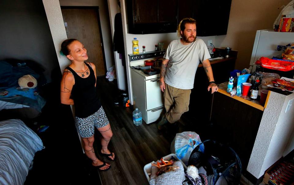 Becca and Danny Glasscock prepare to pack their belongings and check out of a Kennewick motel they were staying at when they ran out of money before the month ended.